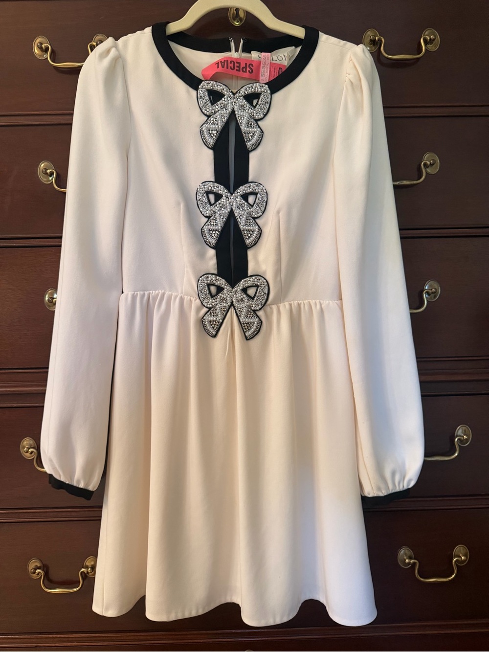SALONI Cream Mini Dress with Black Trim and Crystal Bow Accents